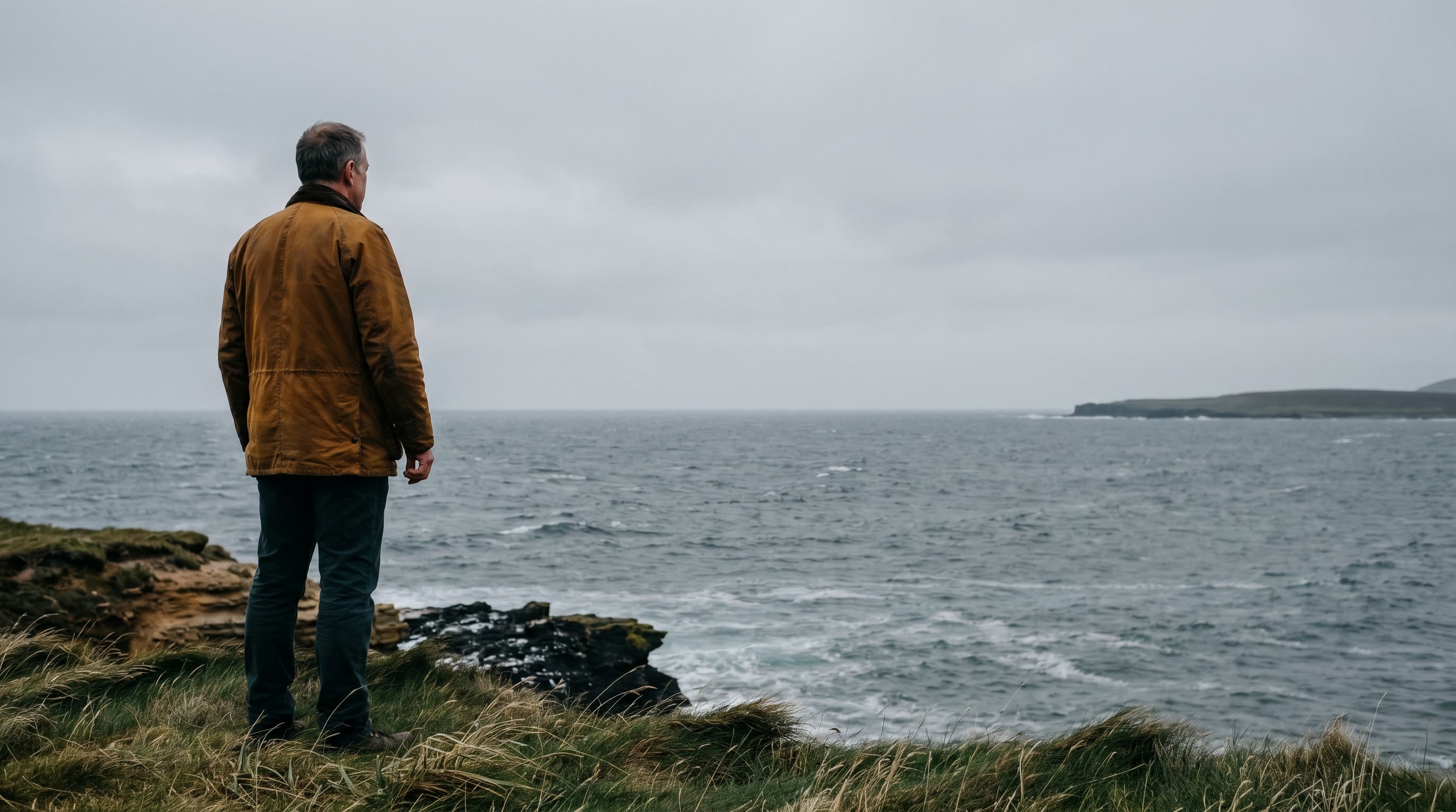 A figure on a clifftop on an Outer Orkney isle, looking out across the North Atlantic — the view from the edge